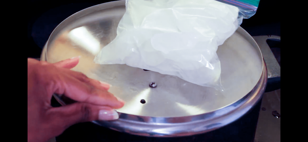pot covered with an inverted lid, topped with Ziploc bags filled with ice cubes