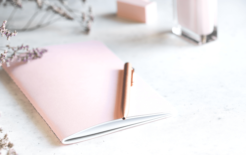 pink journal on white table